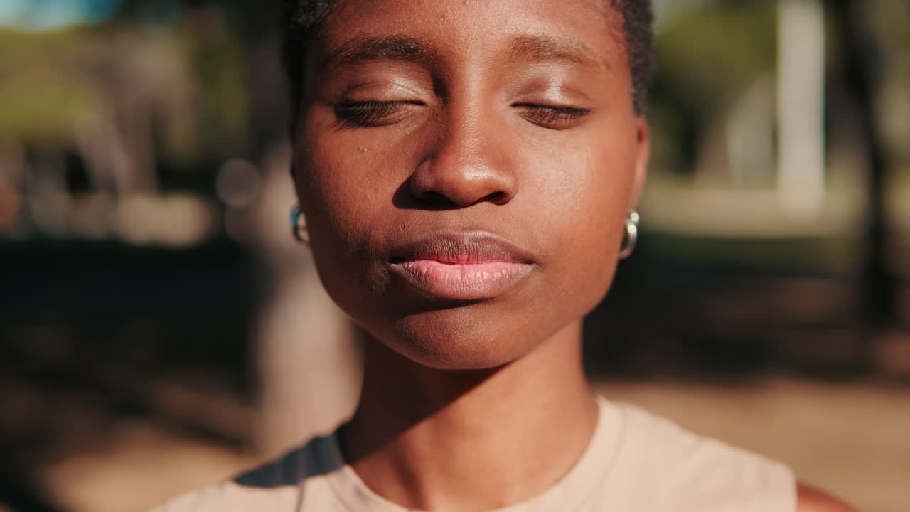 Close-up of Young African American Woman Opening Eyes and Smiling