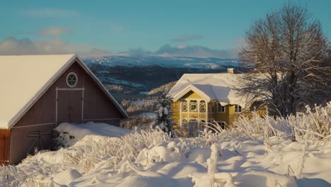 static shot of colorful houses on mountaintop during lighting snowy day in winter - norway, innlandet, valdress, beitostolen, beito