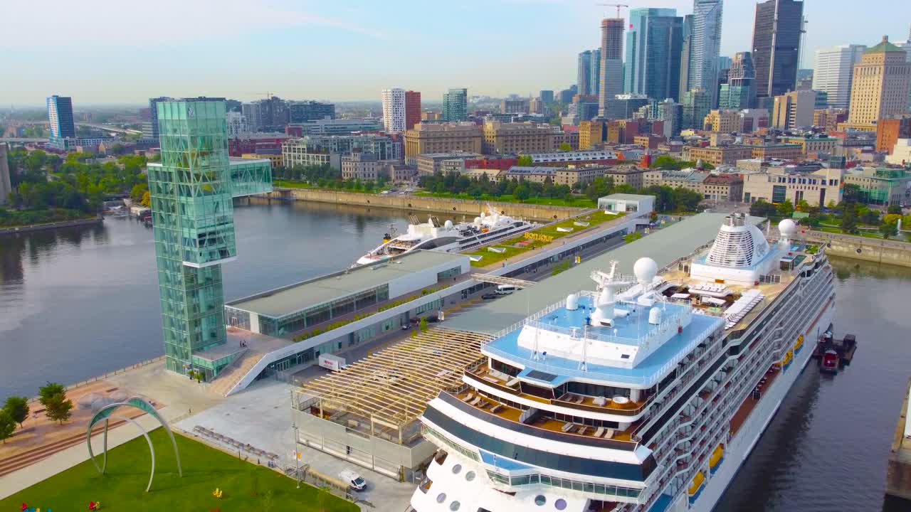 Huge cruise ship is the Regent Seven Seas Grandeur in daytime at harbor of Montréal, Canada.