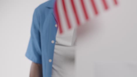 man stands at ballot box in american election deciding how to cast his vote