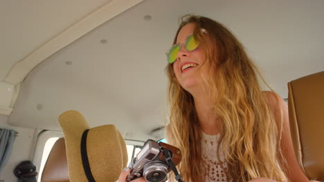 teenage girl enjoying a road trip with a camera