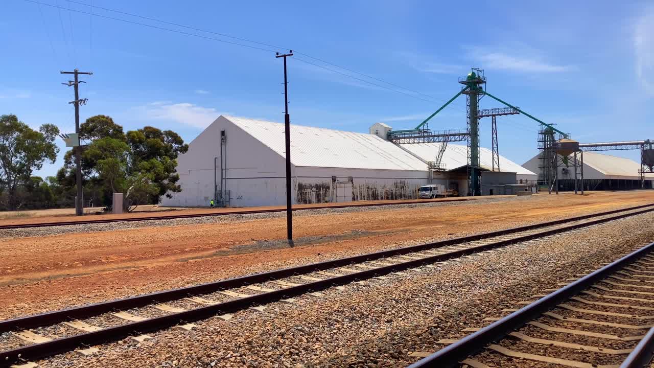 Wheat bins grain storage silos along railroad at train station in Wheatbelt, Western Australia