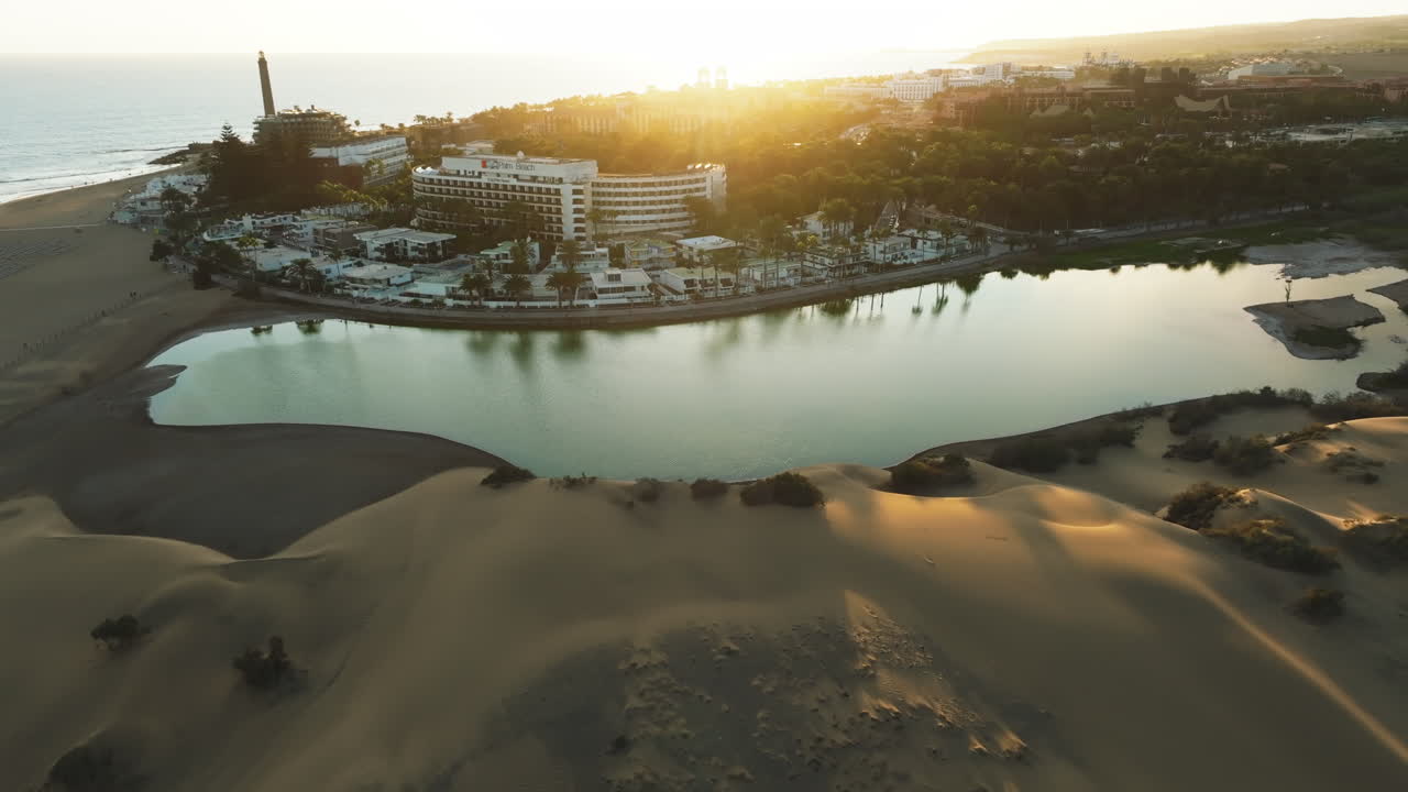 Maspalomas dunes, Gran Canaria: aerial view flying over the dunes and spotting the Maspalomas pond and the lighthouse