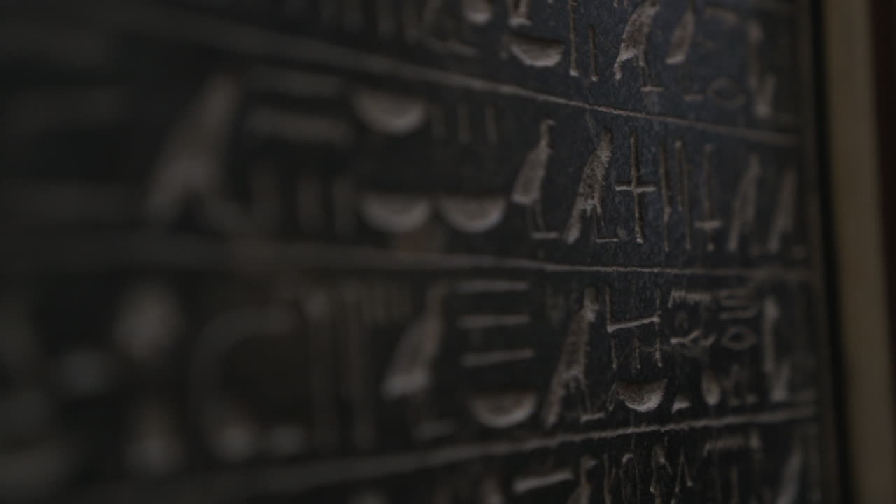 Macro shot moving down wall with ancient Egyptian hieroglyphics written