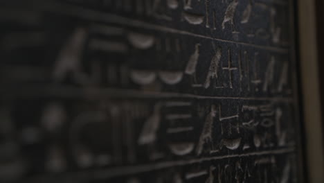 macro shot moving down wall with ancient egyptian hieroglyphics written