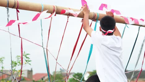 joyful teamwork and community spirit as friends prepare for indonesian independence day celebrations and decorating with traditional colors