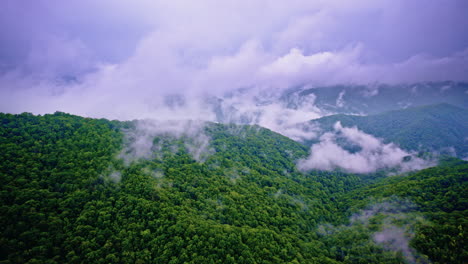 cinematic aerial pass above misty smoky mountain ridges