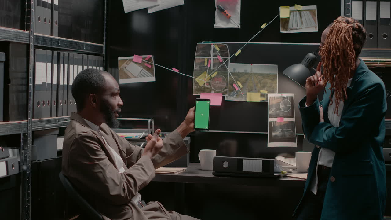 Detectives Analyzing Crime Scene Evidence in Office