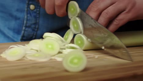 Tracking-right-video-of-slicing-leek-in-the-kitchen