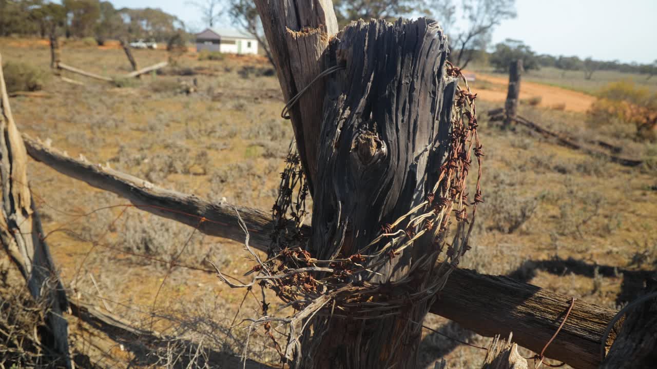 Close up shot of old barb wire around a stockyard fence in the Australian outback.