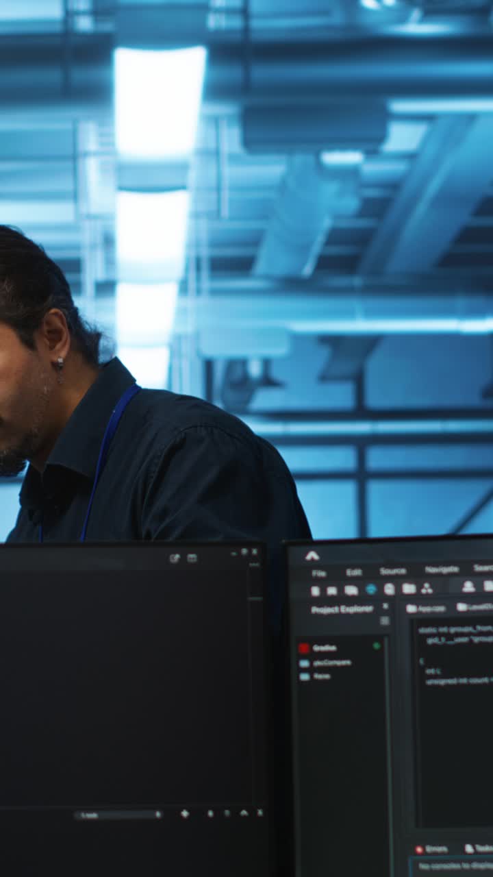 Focused Programmer Working on Code in a Server Room