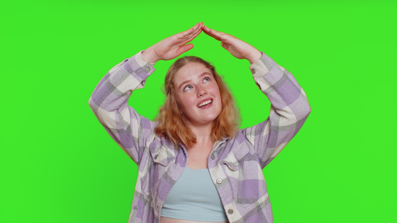 Woman feeling in safe making roof above head with hands insurance security service playing game