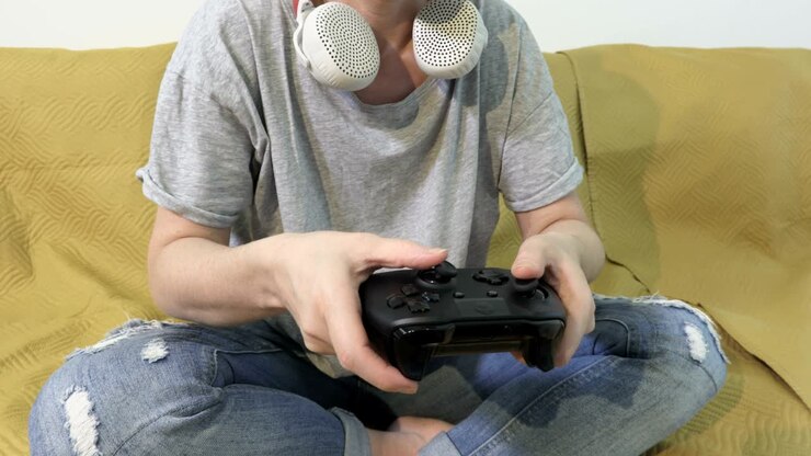 Woman using Gaming Console playing Video Games On The Couch