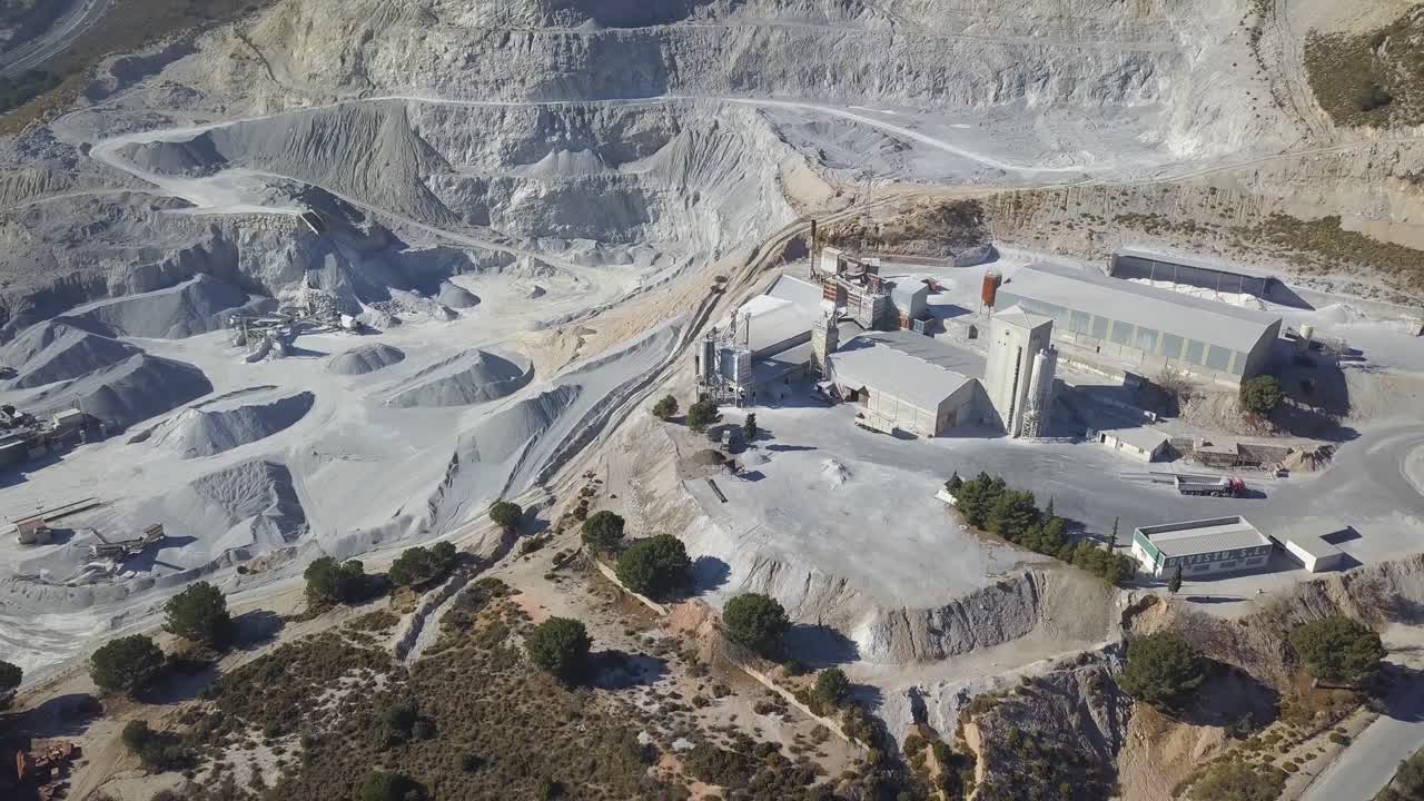 Aerial revealing shot of a big quarry in a mountain