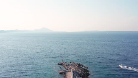 Aerial-dolly-shot-over-a-pier-in-Veli-Losinj-Croatia-looking-out-towards-the-sea