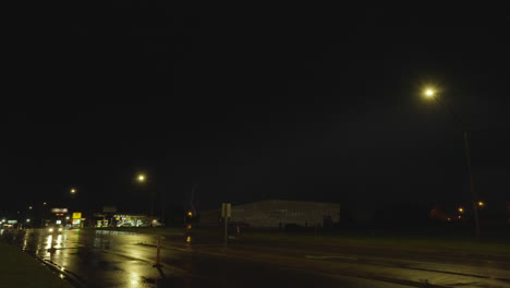 long bolts of lightning flash across the sky above small town