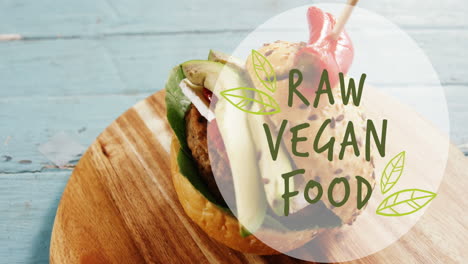 Animation of vegan food text over vegan burger on wooden board