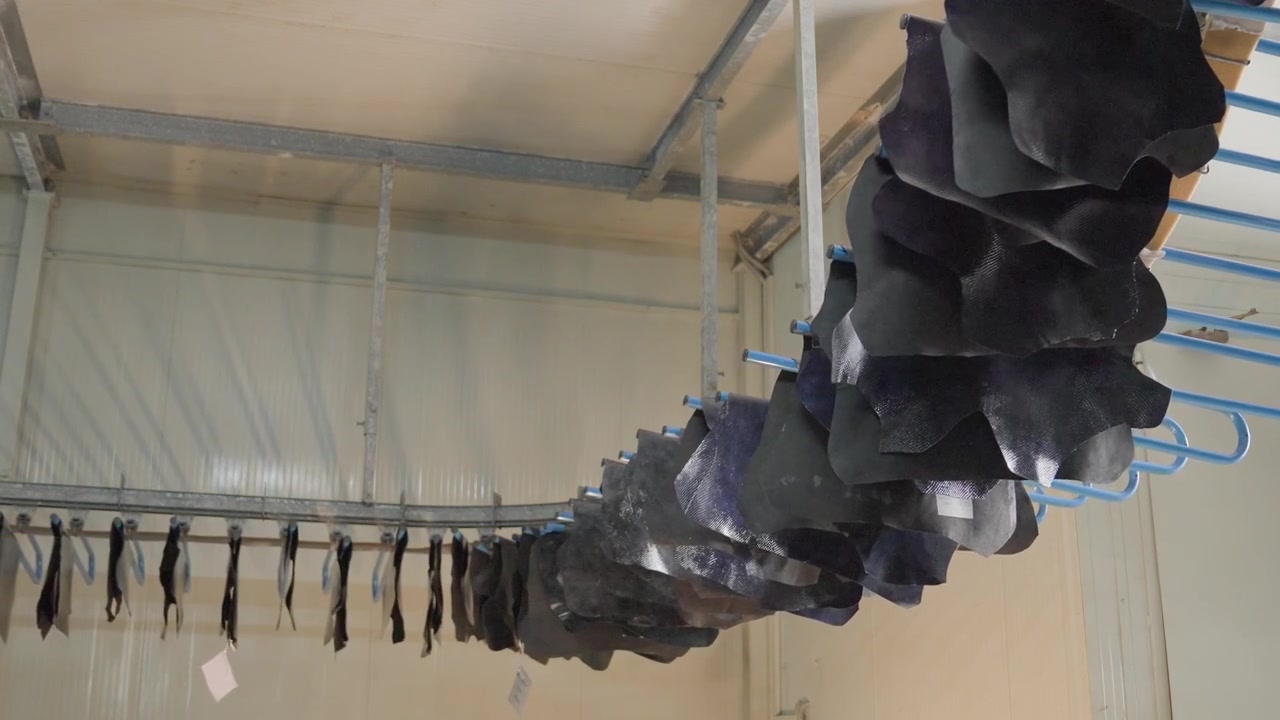 Tanned Animal Hides Hanging On An Automatic Drying Rack In A Leather Manufacturing Factory.