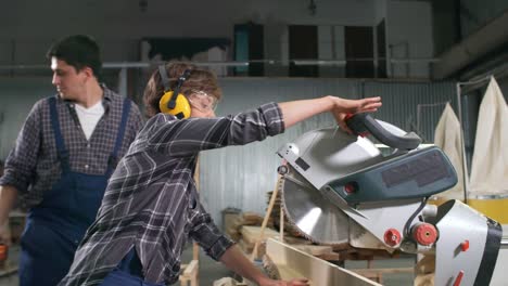 workers using circular saw in joinery