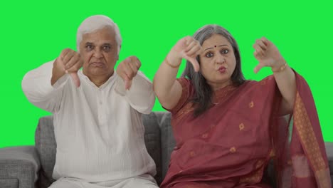 Angry-Old-Indian-couple-showing-thumbs-down-Green-screen