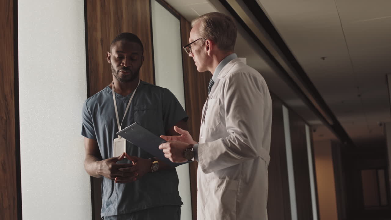 Doctors discussing patient care in hospital corridor