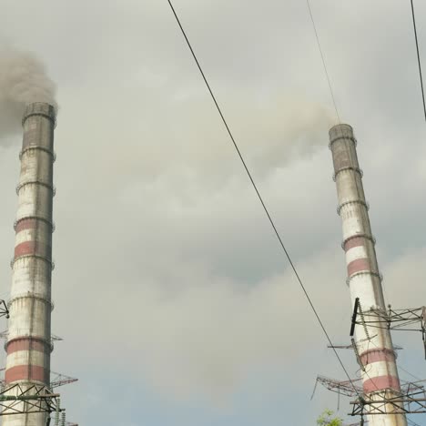 black smoke comes from the pipes of a thermal power plant