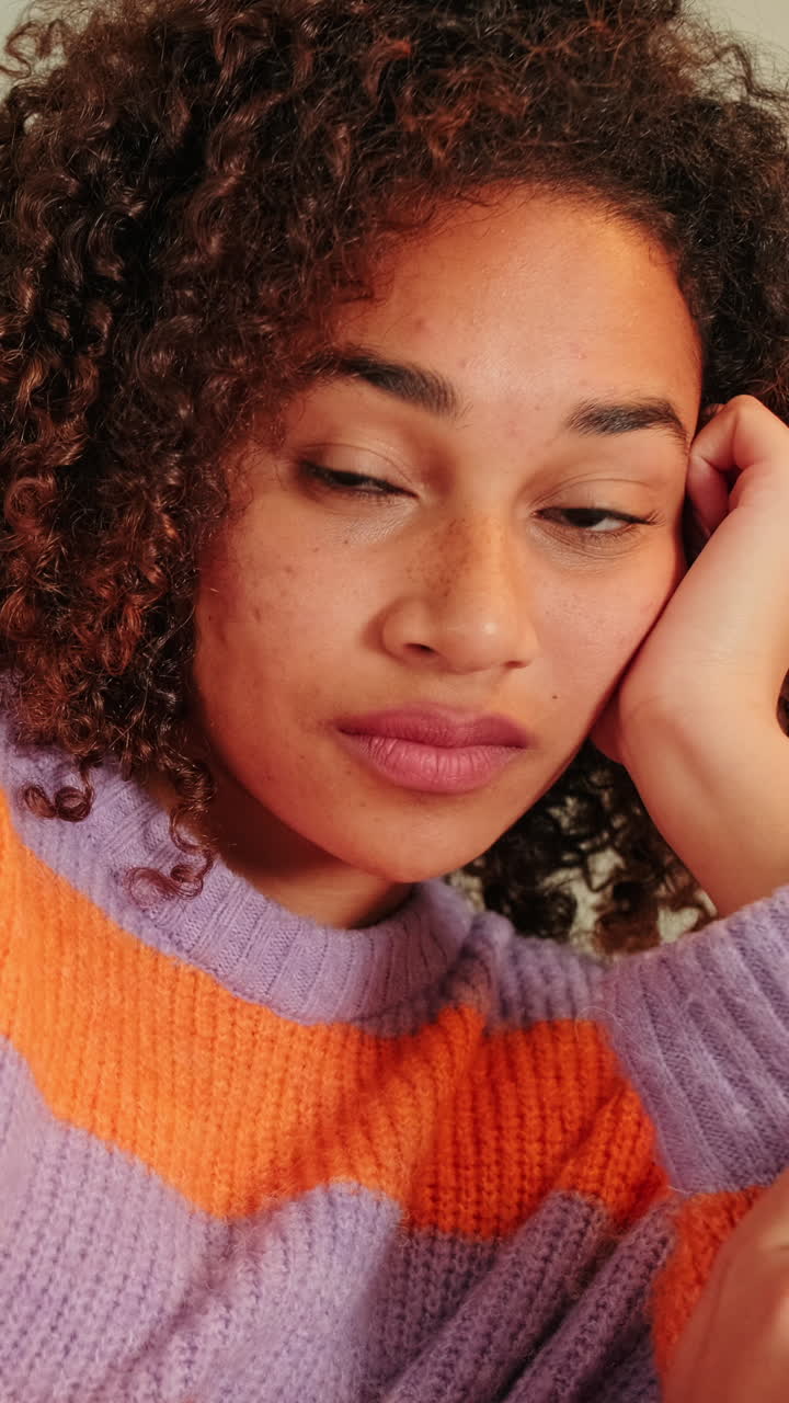 Close Up Portrait of a Thoughtful Young Woman with Curly Hair