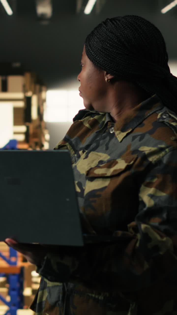 Vertical Video African american soldier managing warehouse defense operations
