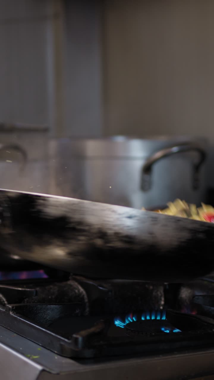 Chef Using Tongs Cooking Spaghetti With Mussels In The Pan