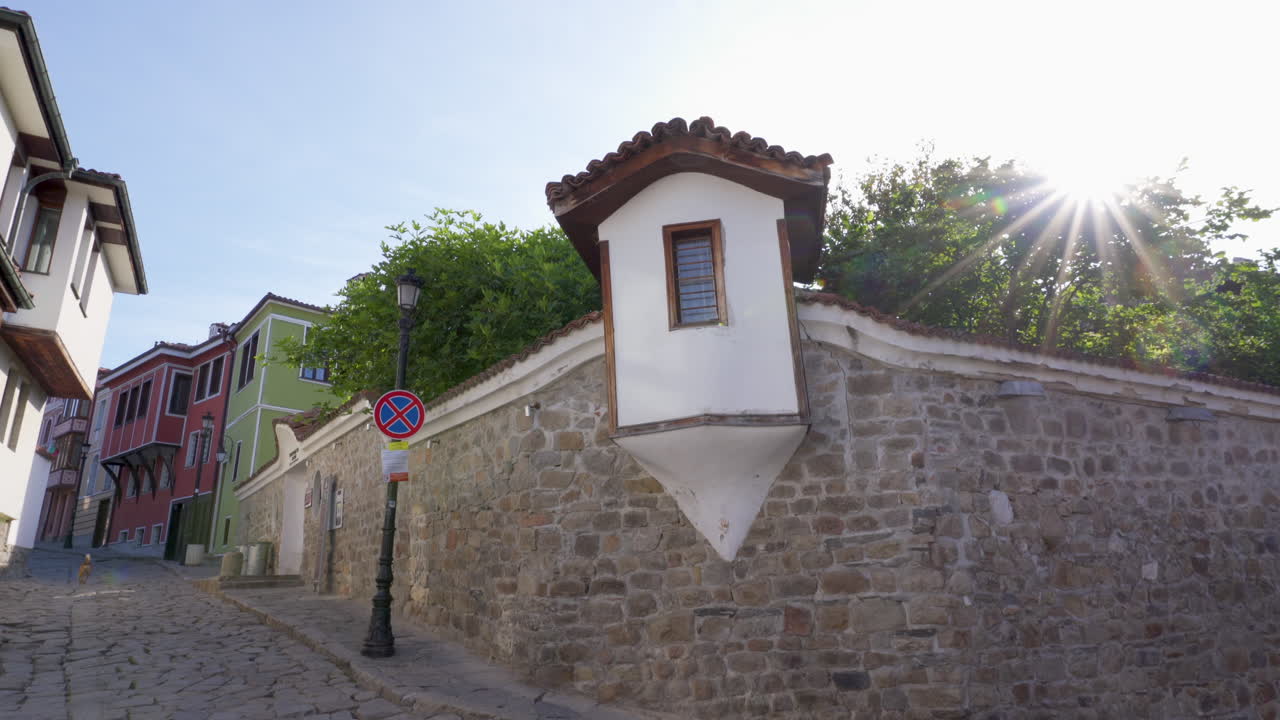 POV shot of a small architectural tower built into the stone wall of the Ethnographic Museum in Plovdiv’s Old Town during springtime