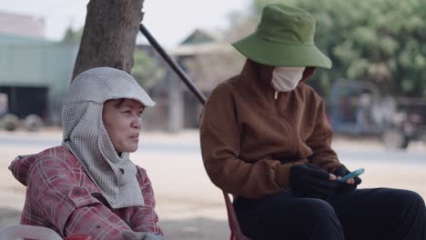 two women workers talking outdoors