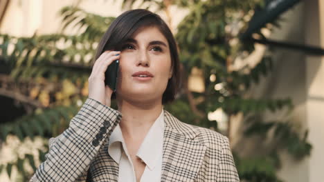 Mujer-Elegante-Haciendo-Una-Llamada-De-Negocios-Al-Aire-Libre.