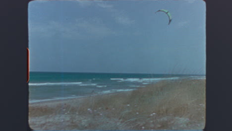 Vintage Beach Scene with Ocean and Kitesurfing Kite