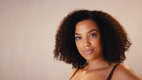 studio portrait shot of smiling confident natural woman in underwear promoting body positivity