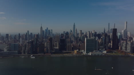 Aerial-footage-of-downtown-skyline-view-dozens-of-tall-skyscrapers.-Busy-road-on-East-river-waterfront.-Manhattan,-New-York-City,-USA