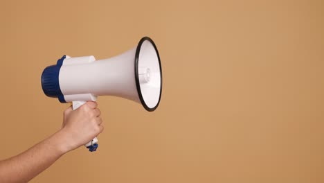 hand of a woman holing a megaphone