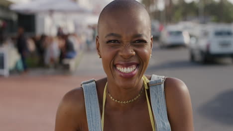 portrait of happy african american woman laughing cheerful enjoying independent lifestyle on summer vacation in warm sunny beachfront street real people series