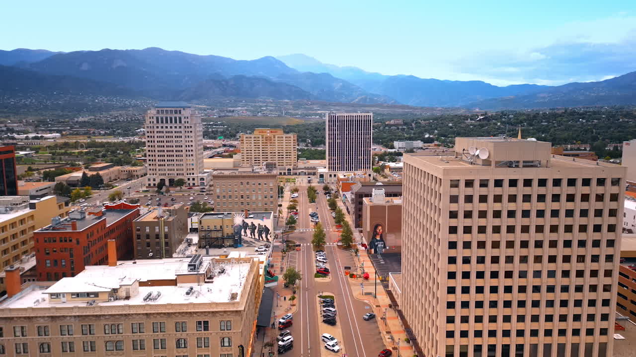 Colorado Springs, USA, 22 July 2025: Going up above the scenery of Colorado Springs, Colorado, USA. Revealing view on the green outskirts of the city surrounded by the mountains
