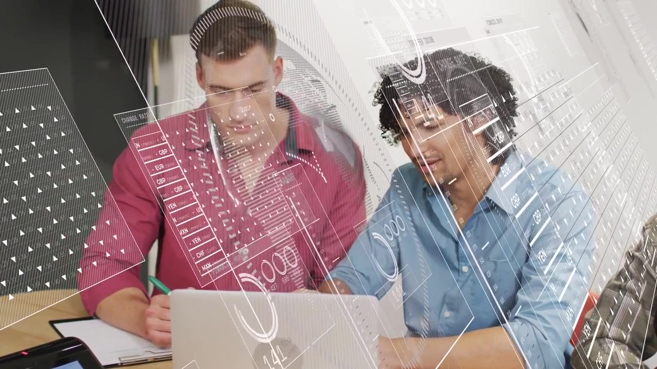 Two men reviewing tech data on laptop, one noting green pen, other typing causing HUD graphics