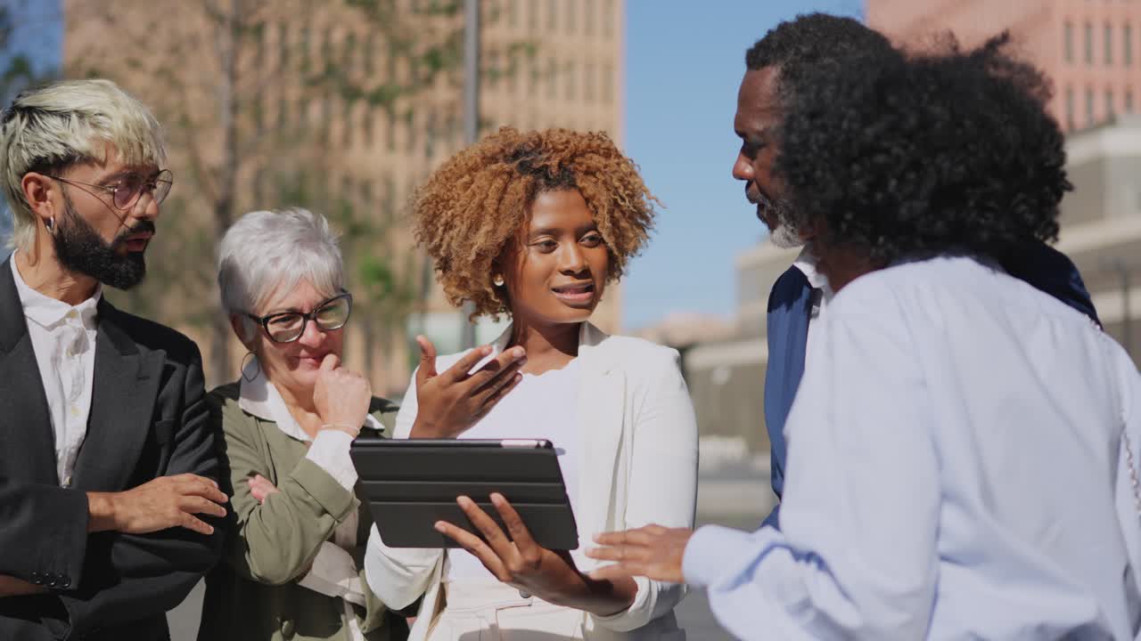 African businesswoman using tablet in an outdoor meeting