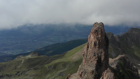 aerial reveal of high mountain wall at rocky summit