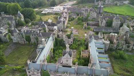 haunted denbigh lunatic asylum, north wales, aerial pull back from near revealing scenery, sunny afternoon