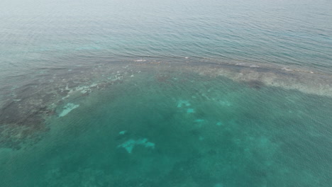 Waves-breaking-on-coral-reef-off-the-coast-of-Jamaican-tropical-clear-ocean-water