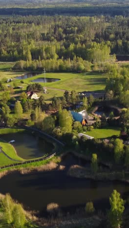 spring green landscape with houses and ponds in katlakalns