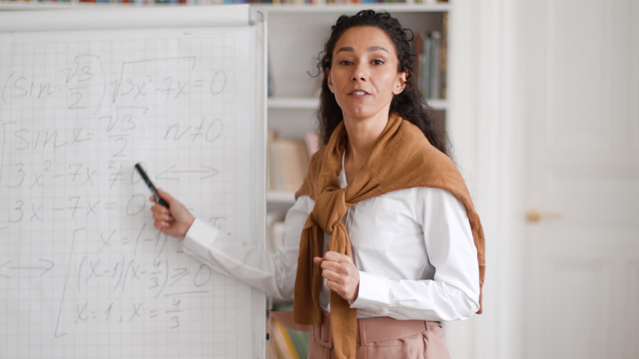 Teacher Presenting Math Equations on a Whiteboard