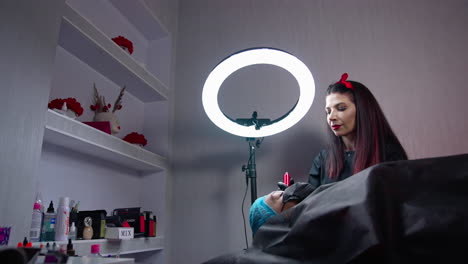 pretty young woman making permanent beauty procedure. cosmetic young specialist doing permanent make up