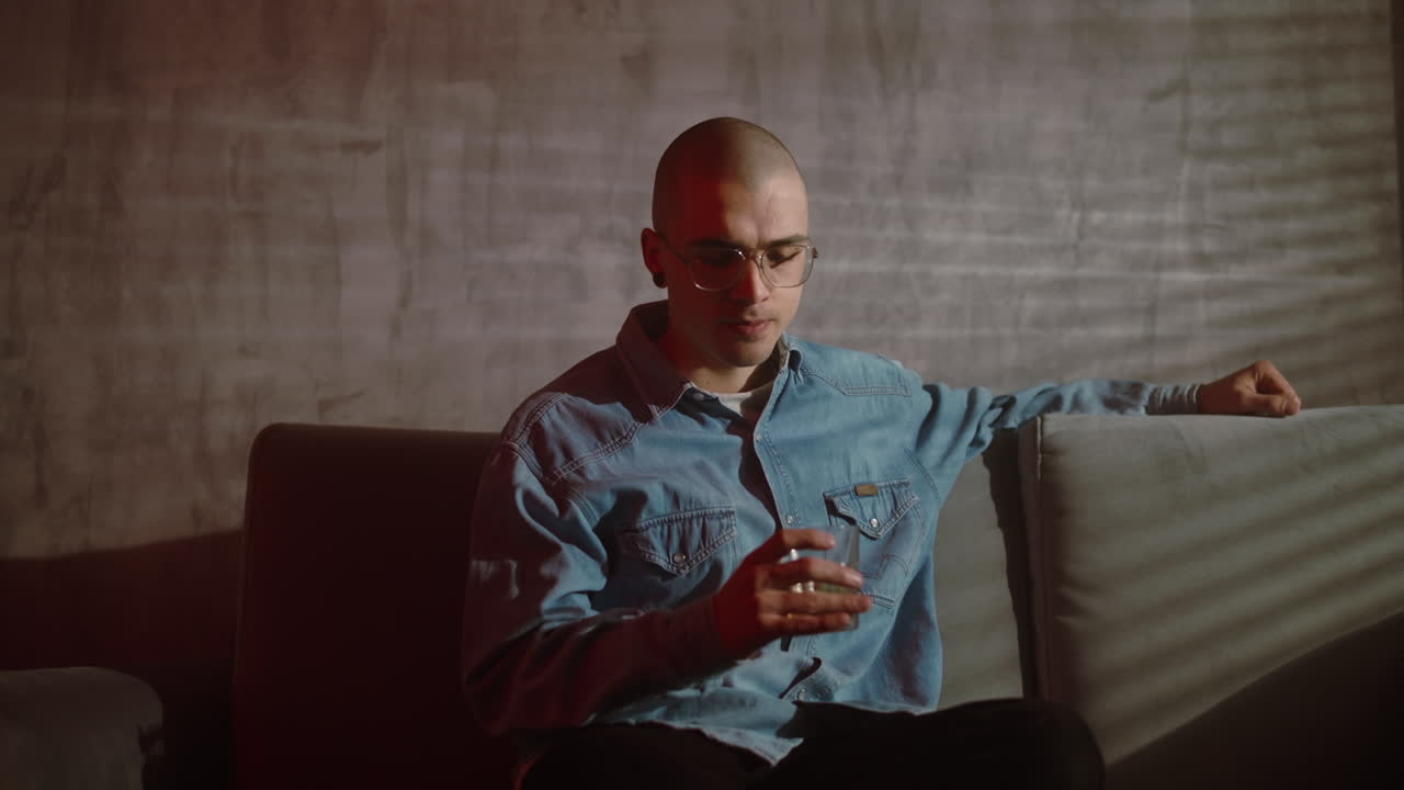 Young Man Drinking on a Couch
