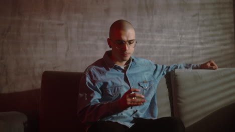 young man drinking on a couch