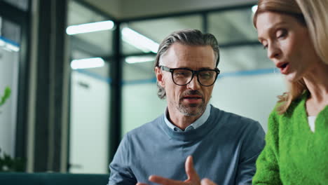 happy colleagues discussing conference room closeup. businessman gesturing hands