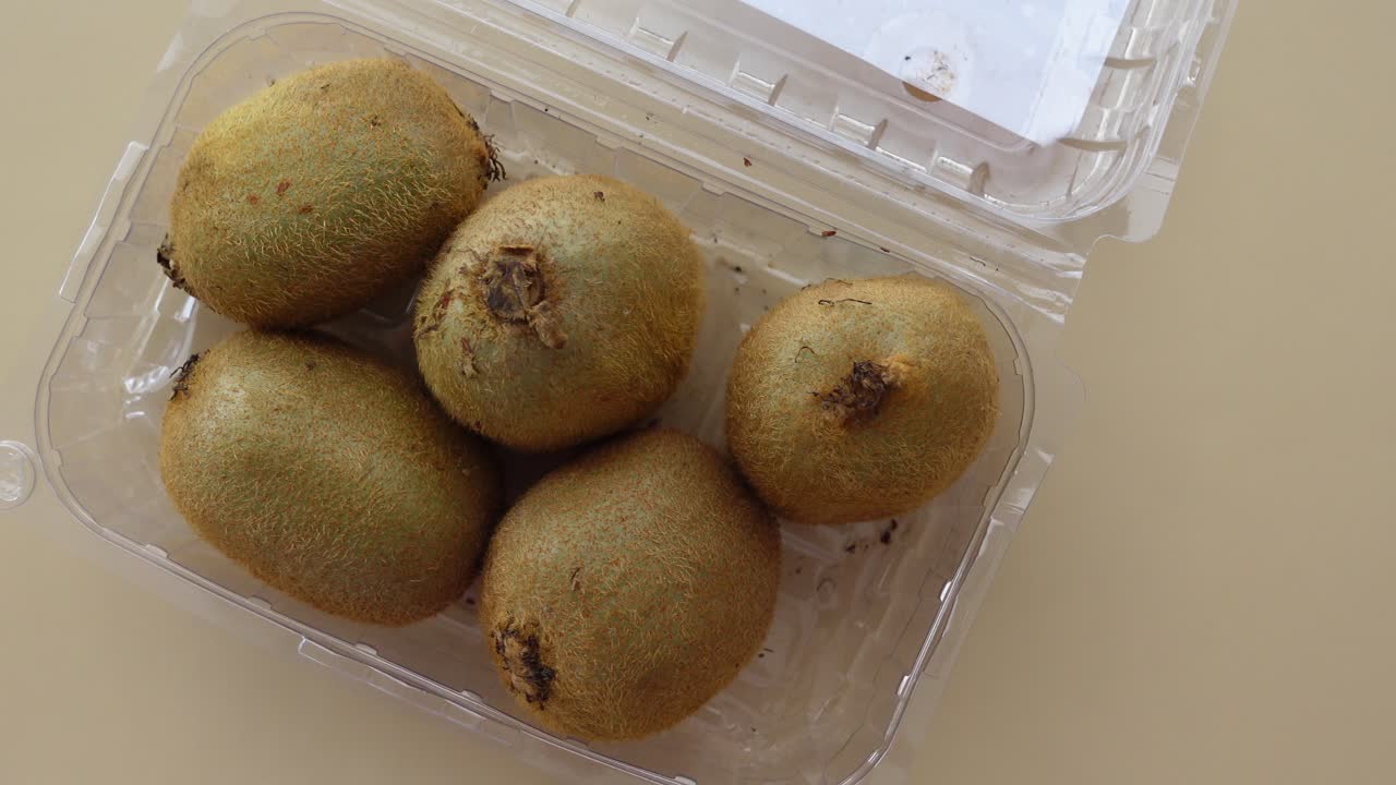 Five Kiwis in a Plastic Container